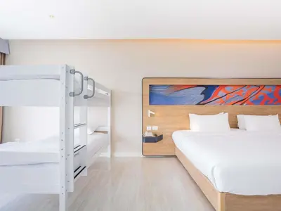 a bedroom with two bunk beds and a bunk bed at Novotel Phuket City Phokeethra in Phuket Town