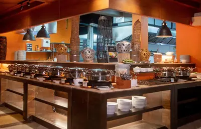 a kitchen with a counter with pots and pans at Thavorn Beach Village Resort & Spa Phuket in Kamala Beach