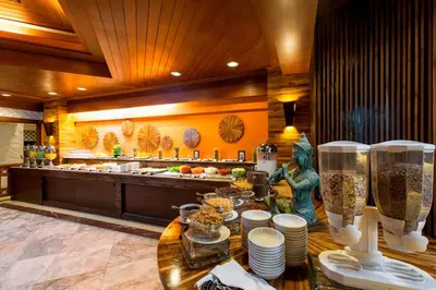 a kitchen with a counter with dishes on a table at Thavorn Beach Village Resort & Spa Phuket in Kamala Beach