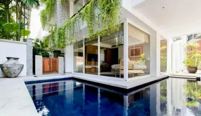 a house with a swimming pool in the yard at The Chava Resort in Surin Beach