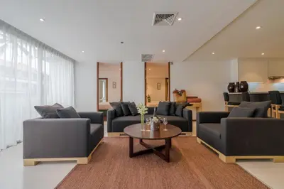 a living room with couches and a table at The Chava Resort in Surin Beach