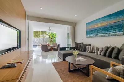 a living room with a couch and a table at The Chava Resort in Surin Beach