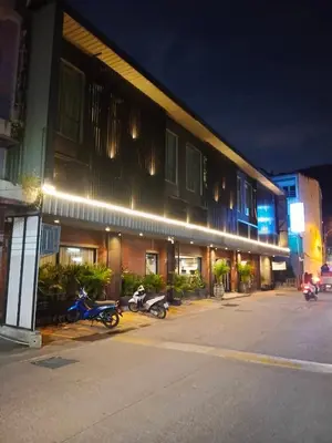 two motorcycles parked outside of a building at night at MORE Patong Hotel in Patong Beach