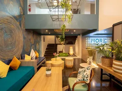 a lobby of a store with couches and tables at MORE Patong Hotel in Patong Beach