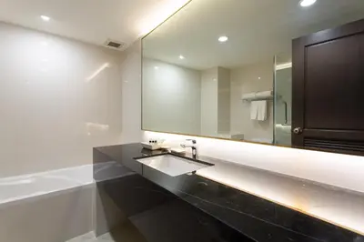 a bathroom with a sink and a large mirror at Krabi Heritage Hotel in Ao Nang Beach