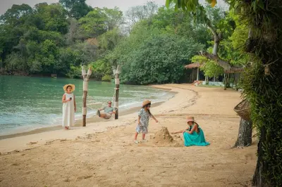 a group of children playing on the beach at Paradise Koh Yao in Ko Yao Noi
