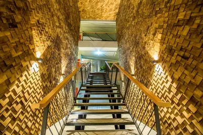 a staircase in a building with a stone wall at The SIS Kata Resort - Adult Only in Kata Beach