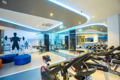 a gym with a lot of treadmills and exercise equipment at The SIS Kata Resort - Adult Only in Kata Beach