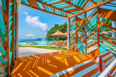 a view of the ocean from the deck of a house at The SIS Kata Resort - Adult Only in Kata Beach