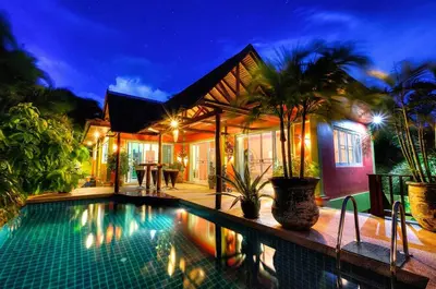 a villa with a swimming pool at night at Chaba Pool Villa Private Tropical Villa With Pool in Nai Harn Beach