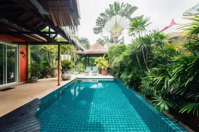 a swimming pool in a house with a garden at Chaba Pool Villa Private Tropical Villa With Pool in Nai Harn Beach