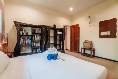 a bedroom with a bed with a blue elephant on it at Chaba Pool Villa Private Tropical Villa With Pool in Nai Harn Beach