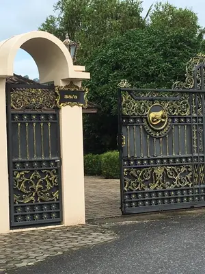 an ornate black metal gate with an archway at Peaceful homestay in Rawai Beach