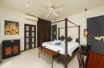 a bedroom with a bed and a ceiling fan at VILLA FLORES 3BR Private Pool 10 min to Nai Harn in Rawai Beach