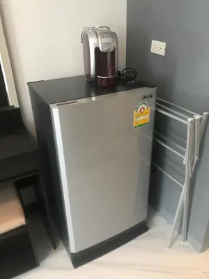 a microwave sitting on top of a refrigerator at Cafe de Paris in Patong Beach