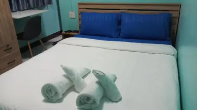 a bed with two stuffed animals on it at Kata S. T. House in Kata Beach