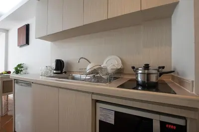 a kitchen with a sink and a stove top oven at Kantary Bay Hotel Phuket in Panwa Beach