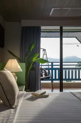 a bedroom with a bed with a view of a balcony at Kantary Bay Hotel Phuket in Panwa Beach
