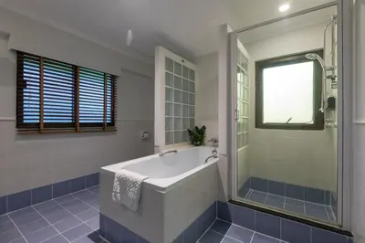 a bathroom with a tub and a glass shower at Kantary Bay Hotel Phuket in Panwa Beach
