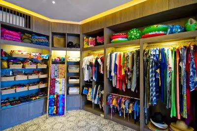 a closet with many different types of clothes at Cape Panwa Hotel Phuket in Panwa Beach