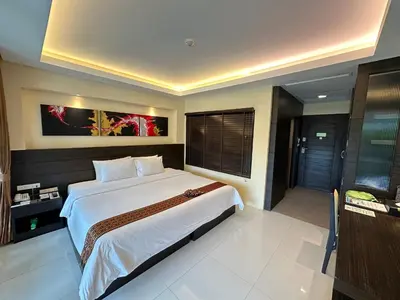 a bedroom with a large bed and a large window at R-Mar Resort and Spa Patong, Phuket in Patong Beach