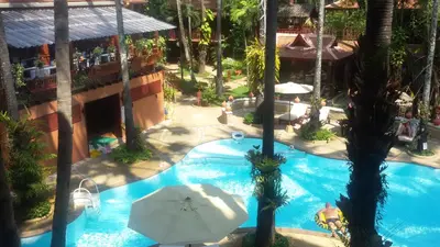 an overhead view of a swimming pool with palm trees at Royal Phawadee Village Patong - 2 Minutes walk to the beach in Patong Beach