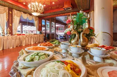 a table with many plates of food on it at Royal Phawadee Village Patong - 2 Minutes walk to the beach in Patong Beach