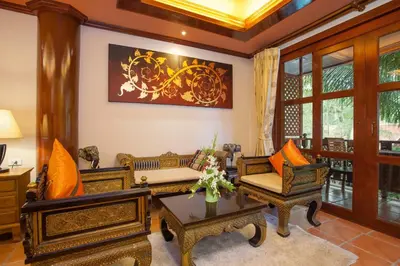 a living room with two couches and a table at Royal Phawadee Village Patong - 2 Minutes walk to the beach in Patong Beach