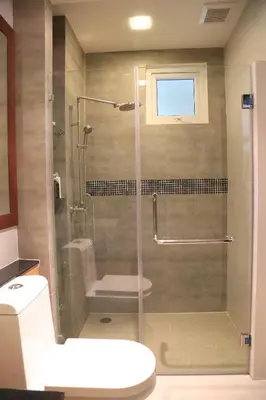 a bathroom with a shower with a toilet and a sink at Sea and Sky Condominium Room #406 in Karon Beach