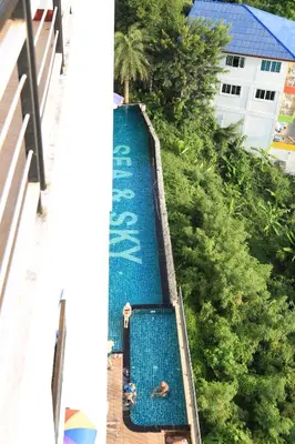 an overhead view of a swimming pool at a resort at Sea and Sky Condominium Room #406 in Karon Beach