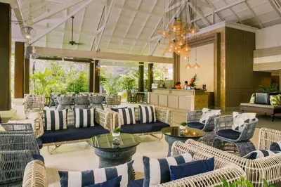 a lobby with couches and chairs and a chandelier at Krabi La Playa Resort in Ao Nang Beach