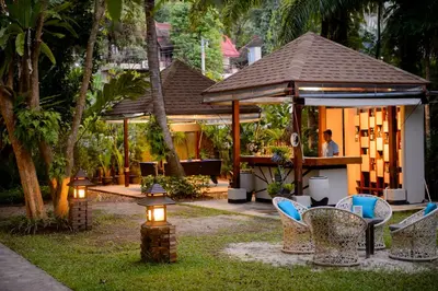 a resort with a table and chairs and a bar at Krabi La Playa Resort in Ao Nang Beach