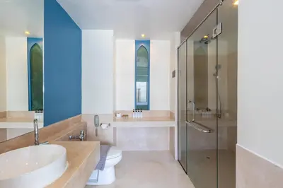 a bathroom with a sink and a toilet and a shower at Navinda Krabi in Ao Nang Beach