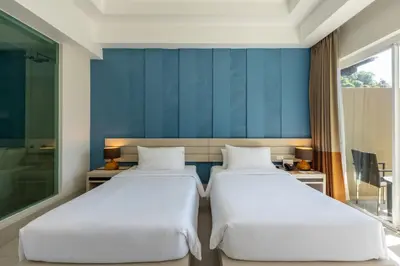 two beds in a room with blue walls at Navinda Krabi in Ao Nang Beach