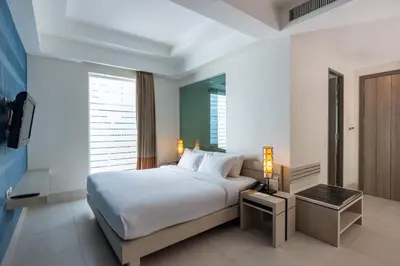 a bedroom with a large white bed and a window at Navinda Krabi in Ao Nang Beach