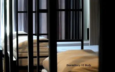 a room with two bunk beds in a room at Phuket Marine Poshtel - SHA Plus in Chalong
