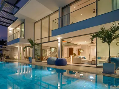 an indoor swimming pool with a house at Malaiwana Residences in Nai Thon Beach