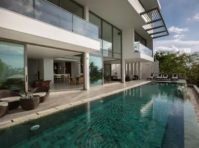 a house with a swimming pool in front of it at Malaiwana Residences in Nai Thon Beach