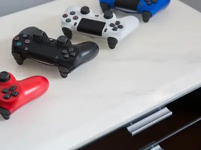 a table with two video game controllers and a red controller at Malaiwana Residences in Nai Thon Beach