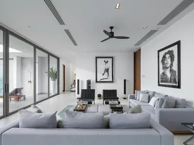 a living room with two couches and a ceiling fan at Malaiwana Residences in Nai Thon Beach