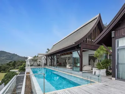 an exterior view of a house with a swimming pool at Malaiwana Villas in Nai Thon Beach