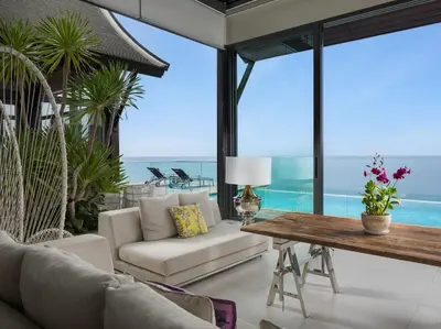 a living room with a couch and a table at Malaiwana Villas in Nai Thon Beach