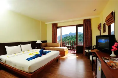 a hotel room with a large bed and a television at Phi Phi Arboreal Resort in Phi Phi Don