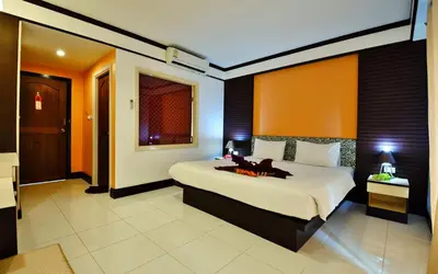 a bedroom with a bed with a fireplace in it at Phi Phi Arboreal Resort in Phi Phi Don