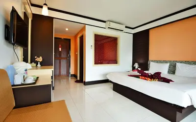a bedroom with a large bed and a television at Phi Phi Arboreal Resort in Phi Phi Don