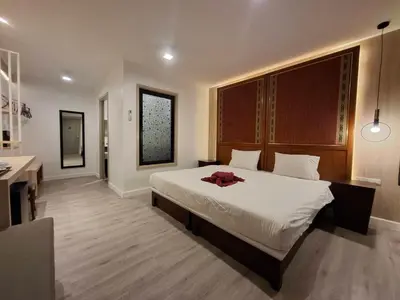 a bedroom with a large bed and a bathroom at Phi Phi Arboreal Resort in Phi Phi Don