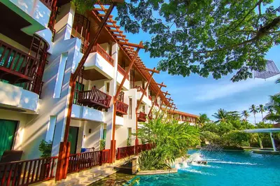 a hotel with a pool in front of a resort at The Elements Krabi Resort - SHA Plus in Klong Muang Beach