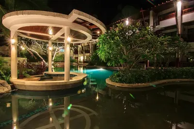 a swimming pool in a hotel at night at The Elements Krabi Resort - SHA Plus in Klong Muang Beach
