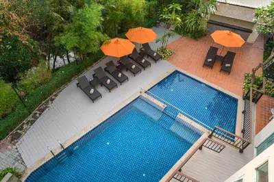 an overhead view of a swimming pool with chairs and umbrellas at Aonang All Seasons Beach Resort in Ao Nang Beach