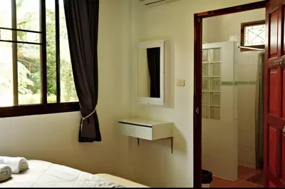 a bathroom with a bed and a sink and a shower at Family Bungalow Kamala in Kamala Beach